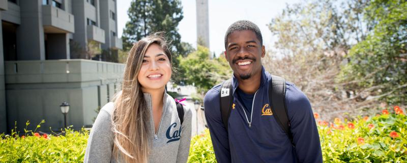 two people standing in front of a building