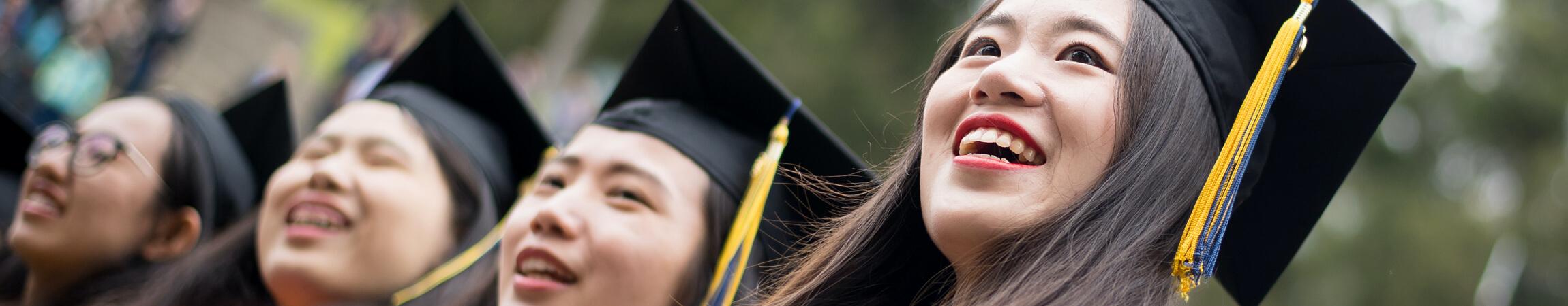 4 women in graduation garb